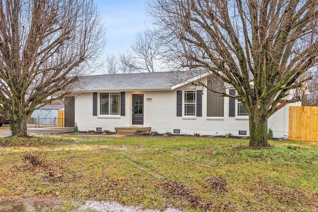 ranch-style home with a front lawn