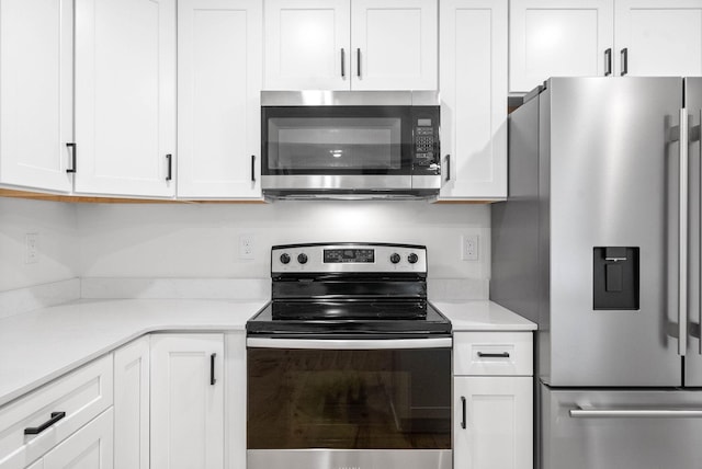 kitchen featuring stainless steel appliances and white cabinets