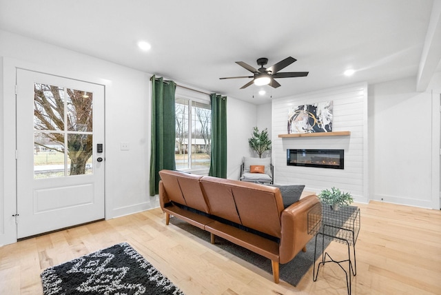 living room with ceiling fan and hardwood / wood-style floors