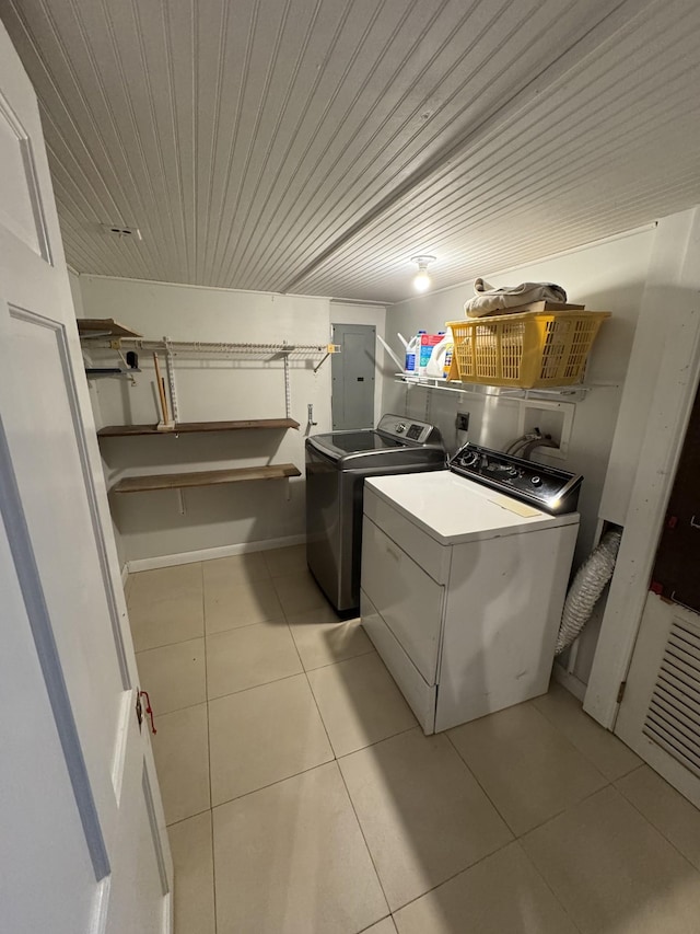 laundry area with light tile patterned floors, laundry area, electric panel, wooden ceiling, and washer and dryer