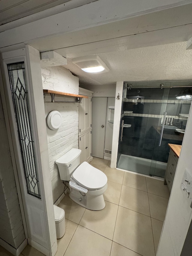 full bathroom with tile patterned flooring, a shower stall, and toilet