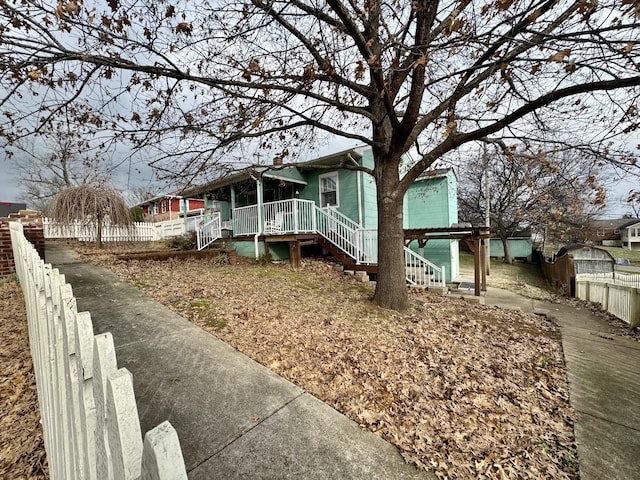 view of front of house with fence and stairway