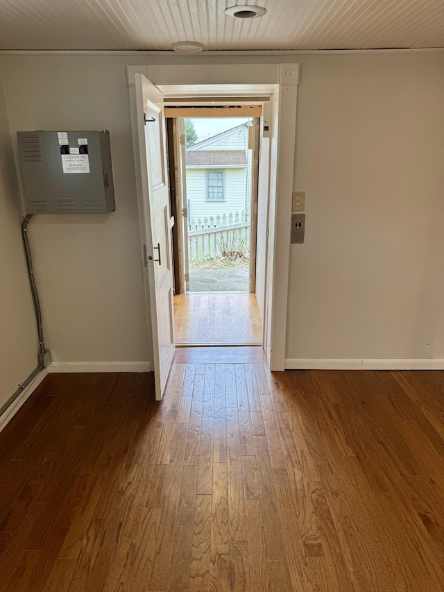 doorway to outside featuring wood ceiling, baseboards, and wood finished floors