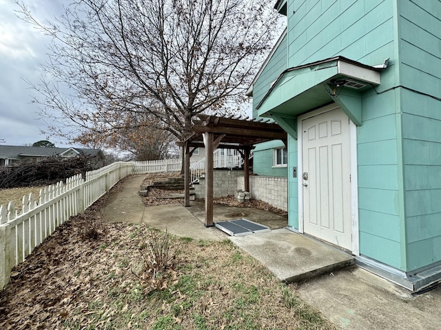 exterior space with a fenced backyard, a pergola, and a patio