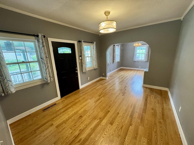 1609 Turner St, Old Hickory, TN 37138 - foyer featuring a textured ceiling, arched walkways, ornamental molding, light wood-style flooring, and baseboards