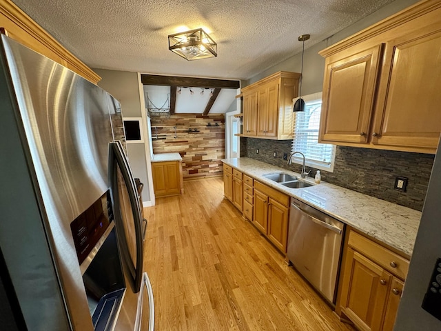 1609 Turner St, Old Hickory, TN 37138 - kitchen with stainless steel appliances, a sink, light wood-style flooring, decorative backsplash, and hanging light fixtures