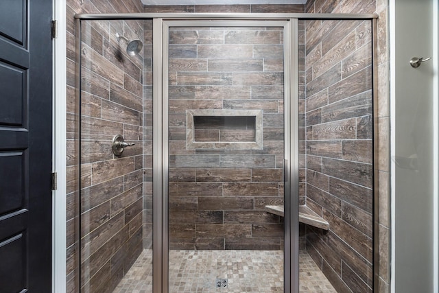 bathroom featuring a shower with door