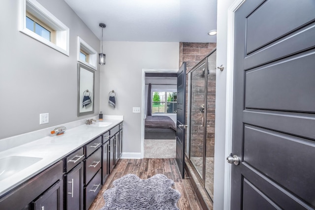 bathroom featuring vanity, hardwood / wood-style floors, and a shower with door