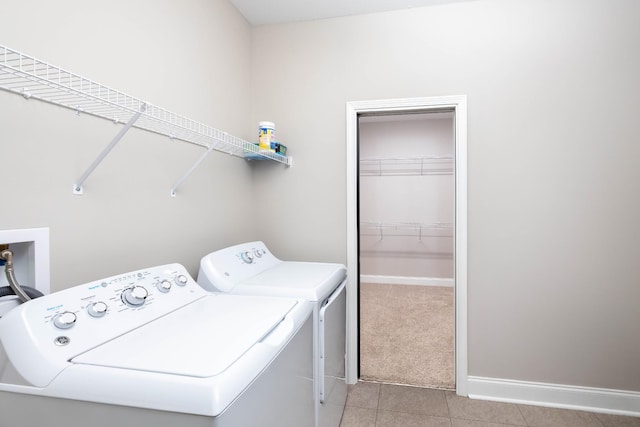 laundry room with light tile patterned flooring and separate washer and dryer