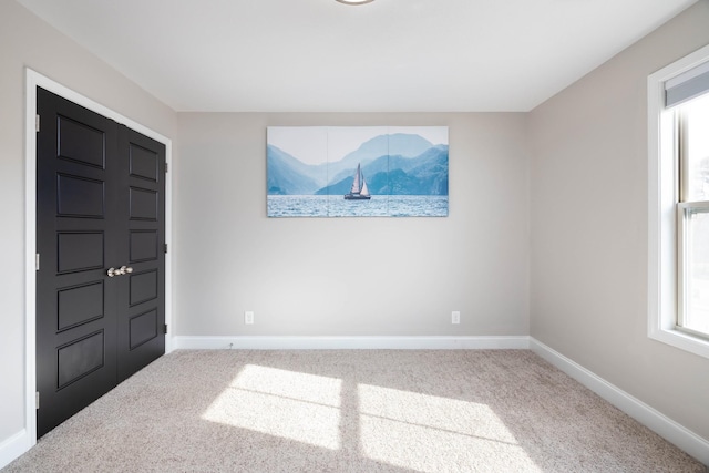 view of carpeted foyer entrance