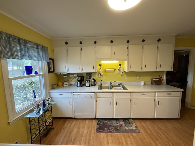 kitchen featuring white cabinetry, sink, dishwasher, and light wood-type flooring