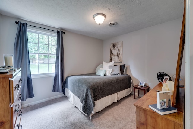 carpeted bedroom with a textured ceiling