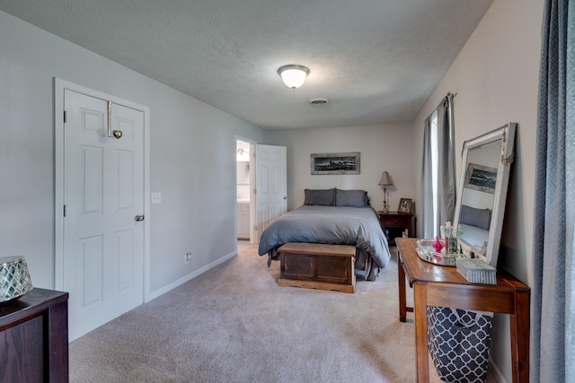 carpeted bedroom featuring a textured ceiling