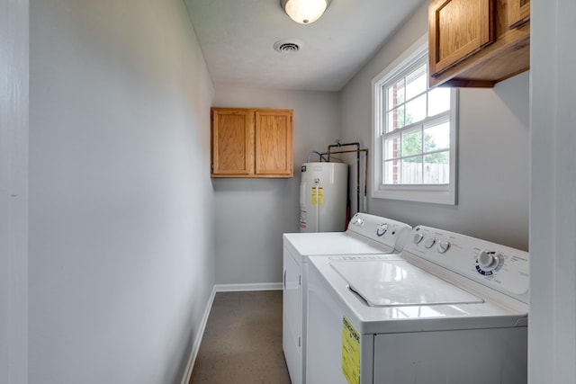 washroom with independent washer and dryer, cabinets, and water heater