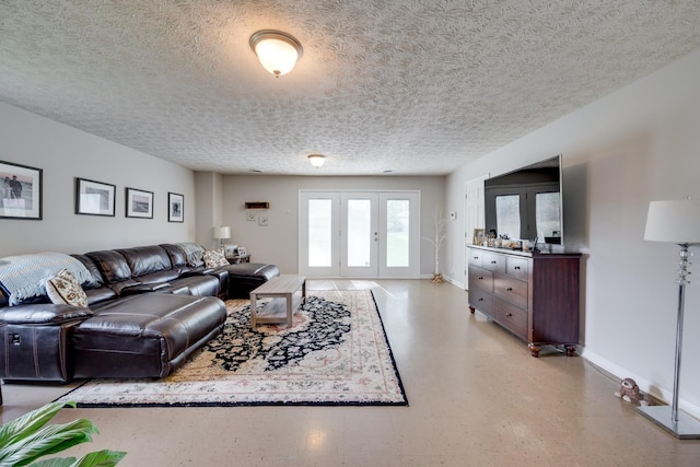 living room with a textured ceiling and french doors