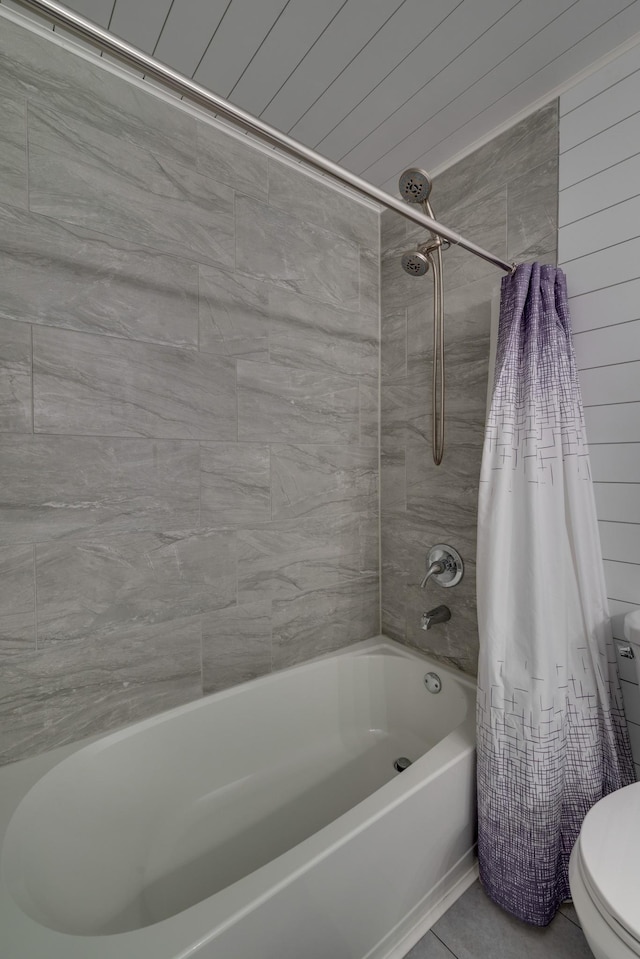 bathroom with tile patterned flooring, shower / tub combo, and toilet