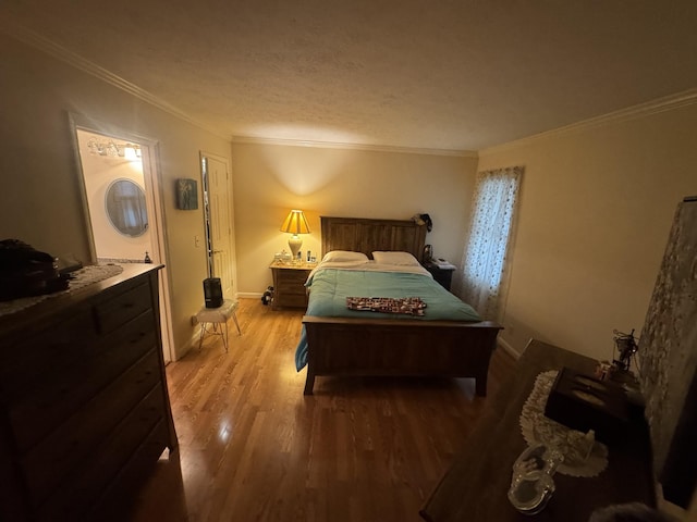 bedroom with ornamental molding, a textured ceiling, and light wood-type flooring