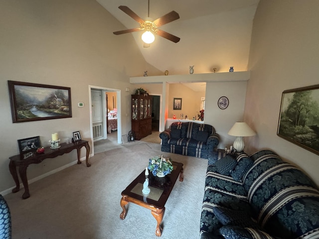 carpeted living room with ceiling fan and high vaulted ceiling