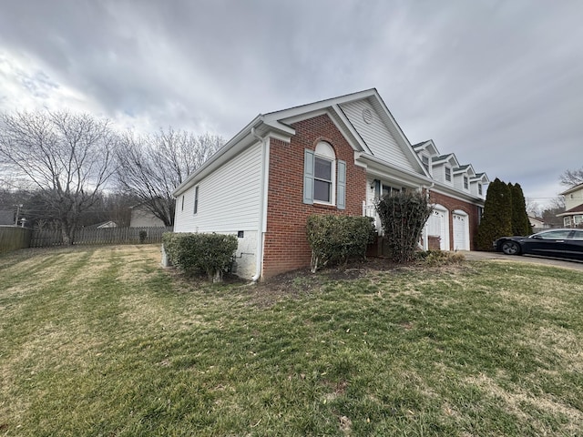 view of side of home with a garage and a yard