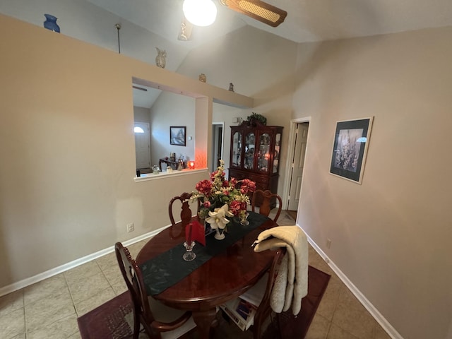 dining area featuring vaulted ceiling and light tile patterned floors