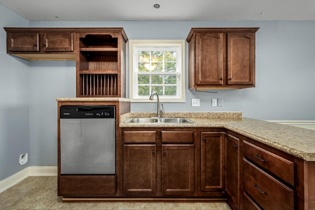 kitchen with light stone countertops, sink, and stainless steel dishwasher