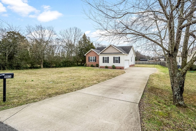 view of front of property with a garage and a front lawn