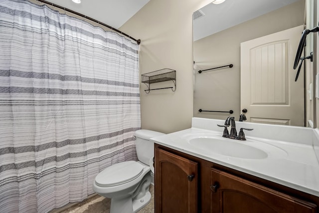 bathroom with vanity, curtained shower, and toilet