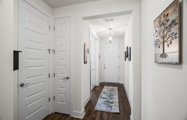 hallway featuring dark wood-type flooring