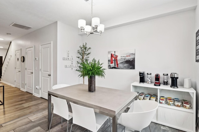 dining area featuring a chandelier and hardwood / wood-style floors