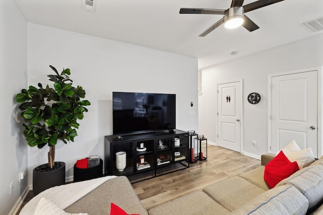 living room with ceiling fan and light wood-type flooring