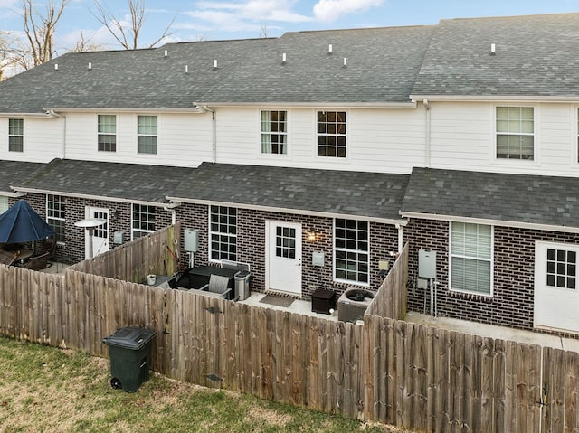 rear view of house featuring central AC unit