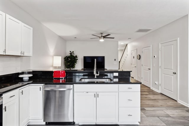 kitchen with sink, stainless steel dishwasher, ceiling fan, decorative backsplash, and white cabinets