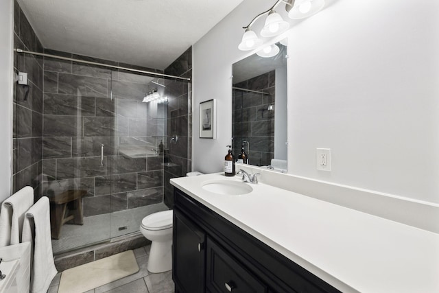 bathroom with tile patterned flooring, vanity, toilet, and walk in shower