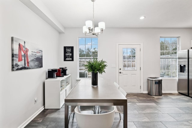 dining space featuring a notable chandelier and a wealth of natural light