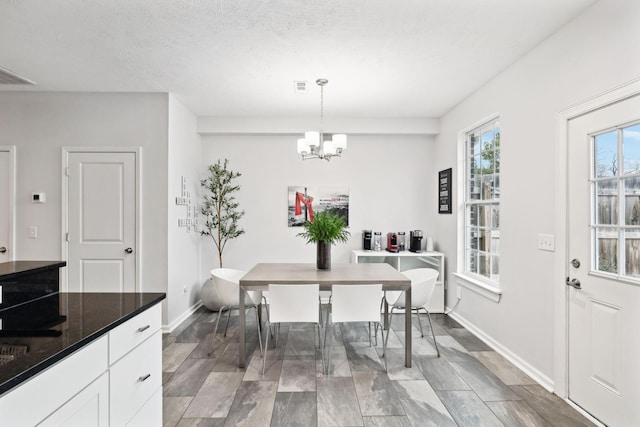 dining room featuring a notable chandelier and a textured ceiling