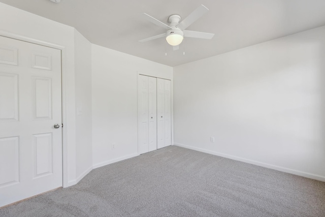 unfurnished bedroom with carpet floors, a closet, and ceiling fan