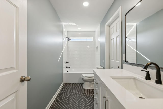 full bathroom with tiled shower / bath, vanity, and toilet