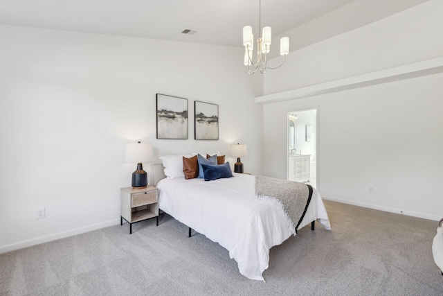 carpeted bedroom with an inviting chandelier and ensuite bath