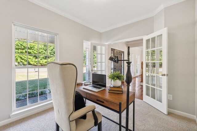 office area featuring french doors, light colored carpet, and crown molding