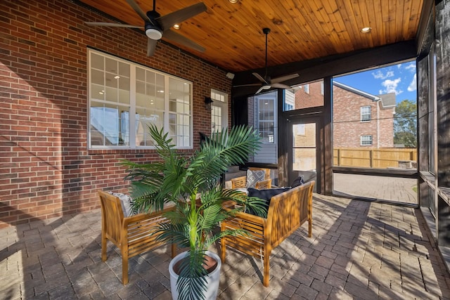 sunroom featuring wood ceiling and ceiling fan