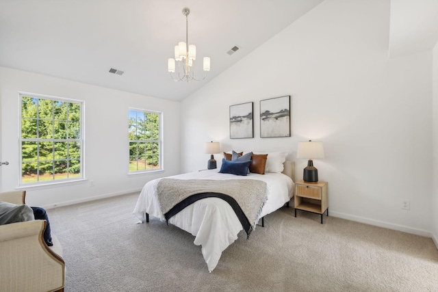 carpeted bedroom with a notable chandelier and high vaulted ceiling