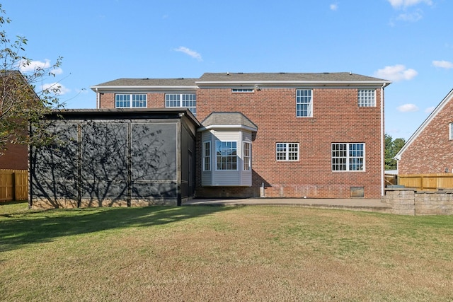 rear view of house with a yard