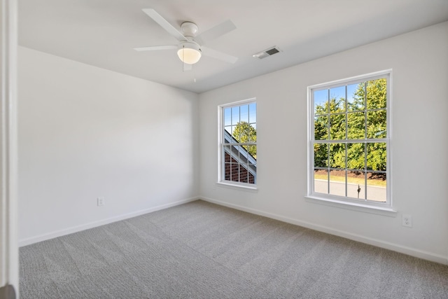 unfurnished room featuring ceiling fan and carpet flooring