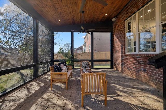 sunroom with wooden ceiling and ceiling fan