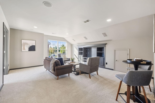 carpeted living room with lofted ceiling