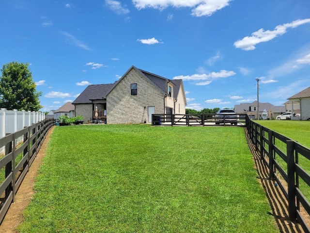 exterior space featuring a fenced backyard and a yard