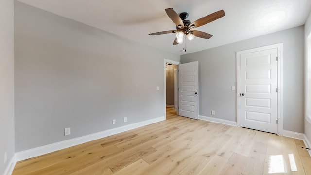 unfurnished bedroom with ceiling fan and light wood-type flooring