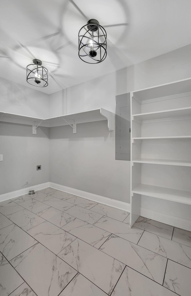 spacious closet with marble finish floor and electric panel