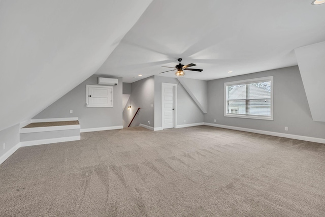 bonus room featuring a ceiling fan, baseboards, carpet flooring, and a wall mounted AC