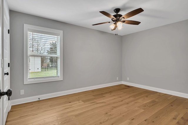 unfurnished room with baseboards, ceiling fan, and light wood finished floors